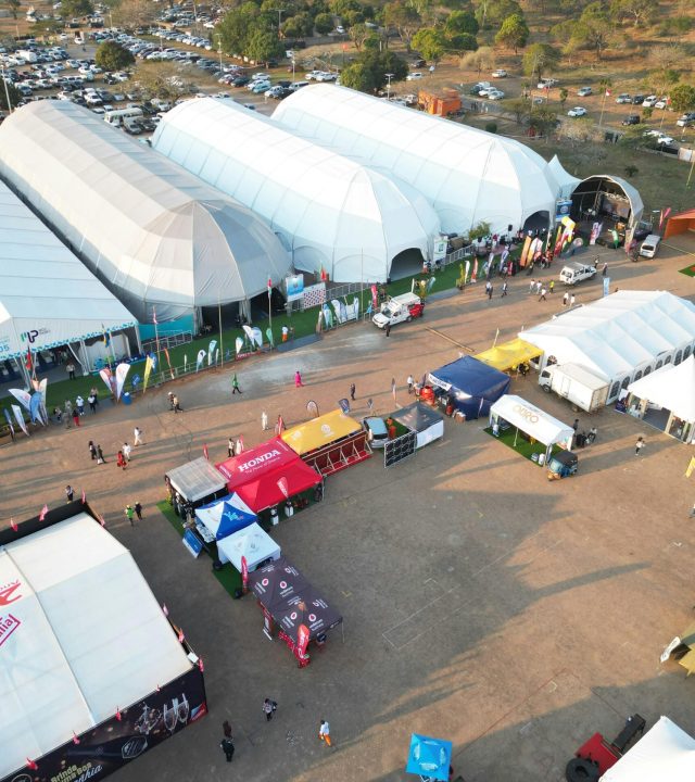 Aerial photo capturing an outdoor event with multiple tents in Maputo, Mozambique.